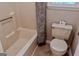 Cozy bathroom showing a toilet, bathtub, and window at 1624 Hampton Locust Grove Rd, Locust Grove, GA 30248