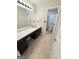 Bright bathroom featuring a double sink vanity with modern fixtures and tile flooring at 1624 Hampton Locust Grove Rd, Locust Grove, GA 30248