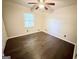 Bedroom features dark wood floors, one window, and a ceiling fan at 1624 Hampton Locust Grove Rd, Locust Grove, GA 30248