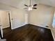 A bright bedroom with dark wood floors, ceiling fan, and access to the bathroom at 1624 Hampton Locust Grove Rd, Locust Grove, GA 30248