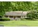 Inviting home featuring a cozy front porch, shuttered windows, and a lush green lawn at 1624 Hampton Locust Grove Rd, Locust Grove, GA 30248