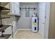 The laundry room is equipped with shelving, cabinets, and a water heater at 1624 Hampton Locust Grove Rd, Locust Grove, GA 30248