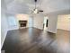 Bright living room with hardwood floors, fireplace, tray ceiling, and a ceiling fan at 1624 Hampton Locust Grove Rd, Locust Grove, GA 30248