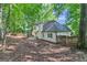 Spacious backyard bordered by mature trees and a sturdy wooden fence at 105 Rosewood Cir, Covington, GA 30016