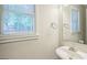 Bright half-bath features natural light and a crisp, clean design at 105 Rosewood Cir, Covington, GA 30016