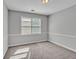 Neutral bedroom offers a cozy retreat with ample natural light and plush carpet at 105 Rosewood Cir, Covington, GA 30016