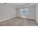 Spacious bedroom featuring a tray ceiling and a window with blinds at 105 Rosewood Cir, Covington, GA 30016