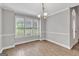 Bright dining room with wood floors and large window for natural light at 105 Rosewood Cir, Covington, GA 30016