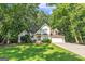 Charming two-story home featuring a well-manicured lawn and lush trees at 105 Rosewood Cir, Covington, GA 30016