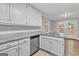 Modern kitchen with granite countertops, stainless steel appliances, and white cabinets at 105 Rosewood Cir, Covington, GA 30016