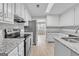 Updated kitchen featuring granite countertops, stainless steel appliances, and white cabinets at 105 Rosewood Cir, Covington, GA 30016