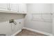This spacious laundry room includes ample cabinet storage and wire shelving at 105 Rosewood Cir, Covington, GA 30016