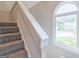 Carpeted staircase with a window that overlooks the yard at 105 Rosewood Cir, Covington, GA 30016
