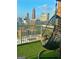 Relaxing balcony featuring artificial turf and a swinging chair with stunning views of the city at 285 Centennial Olympic Park Drive Northwest Nw Dr # 1905, Atlanta, GA 30339