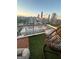 Relaxing balcony featuring artificial turf and a swinging chair with stunning views of the city at 285 Centennial Olympic Park Drive Northwest Nw Dr # 1905, Atlanta, GA 30339