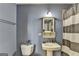 Bathroom featuring a pedestal sink, decorative mirror, and striped shower curtain at 285 Centennial Olympic Park Drive Northwest Nw Dr # 1905, Atlanta, GA 30339
