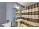 Bathroom featuring a pedestal sink, decorative mirror, and striped shower curtain at 285 Centennial Olympic Park Drive Northwest Nw Dr # 1905, Atlanta, GA 30339