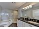 Luxurious bathroom with soaking tub, glass-enclosed shower, and double vanity at 285 Centennial Olympic Park Drive Northwest Nw Dr # 1905, Atlanta, GA 30339