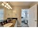 Elegant bathroom with double sinks, granite countertops, and a glimpse into the bedroom at 285 Centennial Olympic Park Drive Northwest Nw Dr # 1905, Atlanta, GA 30339