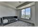 Bedroom with modern grey day bed with large window and city views at 285 Centennial Olympic Park Drive Northwest Nw Dr # 1905, Atlanta, GA 30339
