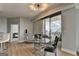 Open-concept dining area with a glass table, balcony access, and city views at 285 Centennial Olympic Park Drive Northwest Nw Dr # 1905, Atlanta, GA 30339
