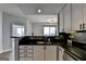 Well-appointed kitchen with breakfast bar overlooking a spacious living area and cityscape views at 285 Centennial Olympic Park Drive Northwest Nw Dr # 1905, Atlanta, GA 30339