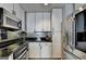The streamlined kitchen features stainless steel appliances, undermount sink, and stylish gray backsplash at 285 Centennial Olympic Park Drive Northwest Nw Dr # 1905, Atlanta, GA 30339