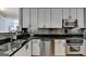 Modern kitchen features stainless steel appliances, granite countertops, and sleek white cabinetry at 285 Centennial Olympic Park Drive Northwest Nw Dr # 1905, Atlanta, GA 30339