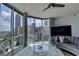 This modern living room boasts floor-to-ceiling windows with panoramic city views at 285 Centennial Olympic Park Drive Northwest Nw Dr # 1905, Atlanta, GA 30339