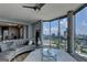 This modern living room boasts floor-to-ceiling windows with panoramic city views at 285 Centennial Olympic Park Drive Northwest Nw Dr # 1905, Atlanta, GA 30339