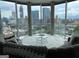 Bright living room with floor-to-ceiling windows showcasing a stunning city skyline view at 285 Centennial Olympic Park Drive Northwest Nw Dr # 1905, Atlanta, GA 30339