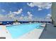 Rooftop pool with lounge chairs and clear blue sky at 285 Centennial Olympic Park Drive Northwest Nw Dr # 1905, Atlanta, GA 30339