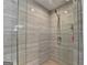 Modern glass shower with elegant fixtures and contemporary tile design at 285 Centennial Olympic Park Drive Northwest Nw Dr # 1905, Atlanta, GA 30339