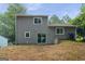 View of backyard featuring vinyl siding and sliding glass doors leading to the outside area, ready for landscaping at 2069 Countydown Ln, Stone Mountain, GA 30088