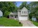 Charming home featuring light gray siding, an attached garage, and a welcoming front yard with a well-manicured lawn at 2069 Countydown Ln, Stone Mountain, GA 30088