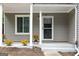 Inviting covered front porch adorned with potted flowers, offering a cozy entrance with a well-maintained door and accents at 2069 Countydown Ln, Stone Mountain, GA 30088