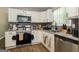 Well-appointed kitchen features stainless steel appliances, granite countertops, and white cabinetry, offering a modern and functional space at 2069 Countydown Ln, Stone Mountain, GA 30088