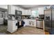 Modern kitchen features stainless steel appliances, white cabinets, granite countertops, and stylish backsplash, perfect for cooking at 2069 Countydown Ln, Stone Mountain, GA 30088