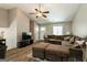 Spacious living room with wood flooring, ceiling fan, and comfortable brown sectional sofa and ottoman at 2069 Countydown Ln, Stone Mountain, GA 30088