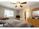 Comfortable main bedroom with ceiling fan, dresser, and serene natural light from the window at 2069 Countydown Ln, Stone Mountain, GA 30088