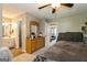 Comfortable main bedroom with ceiling fan and dresser leading to en suite bathroom at 2069 Countydown Ln, Stone Mountain, GA 30088