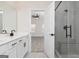 Bright bathroom featuring dual vanity with sleek black fixtures and a glass-enclosed shower at 608 Cantrell Drive, Dallas, GA 30157
