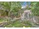 Beautiful backyard with a stone patio, mossy stone pavers, mature trees, and a view of the house at 606 Wingspread, Peachtree City, GA 30269