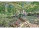 Multi-tiered backyard with stone steps and lush greenery offers a serene escape at 606 Wingspread, Peachtree City, GA 30269