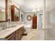 Chic bathroom featuring double sinks, free-standing tub, unique tile work, and natural light, adding modern elegance at 606 Wingspread, Peachtree City, GA 30269