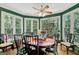 Cozy breakfast nook with many windows, a ceiling fan and an oval wood table at 606 Wingspread, Peachtree City, GA 30269