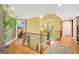 Bright foyer with hardwood floors, staircase, and decorative plants, creating a welcoming entrance at 606 Wingspread, Peachtree City, GA 30269
