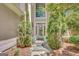 Elegant front door with glass, transom window, and symmetrical landscaping at 606 Wingspread, Peachtree City, GA 30269