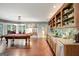 Bright game room featuring a pool table, hardwood floors, and a kitchenette with stainless steel appliances at 606 Wingspread, Peachtree City, GA 30269