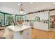 Bright kitchen with white cabinets, hardwood floors, and a large island at 606 Wingspread, Peachtree City, GA 30269